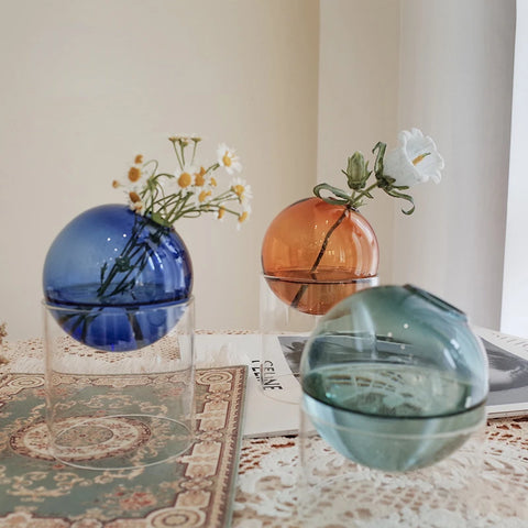 Selection of coloured vases with flowers in