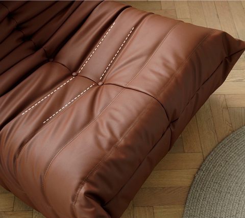 Close up of leather-look slouch couch chair.