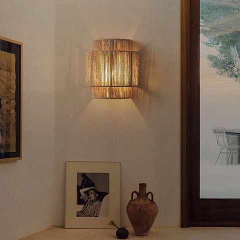 Woven wall light on wall above table with accessories 